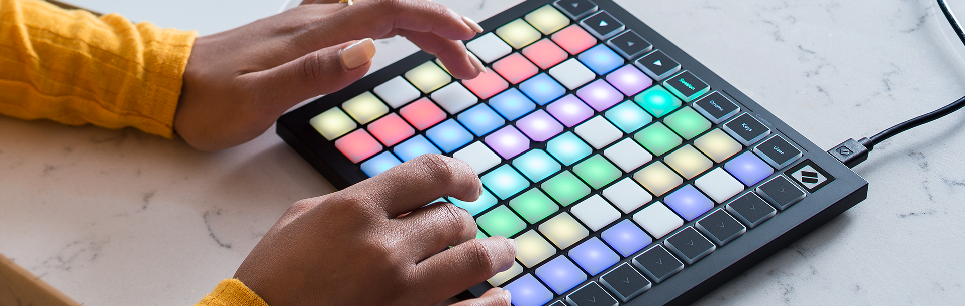 Close-up of woman's hands using a Launchkey