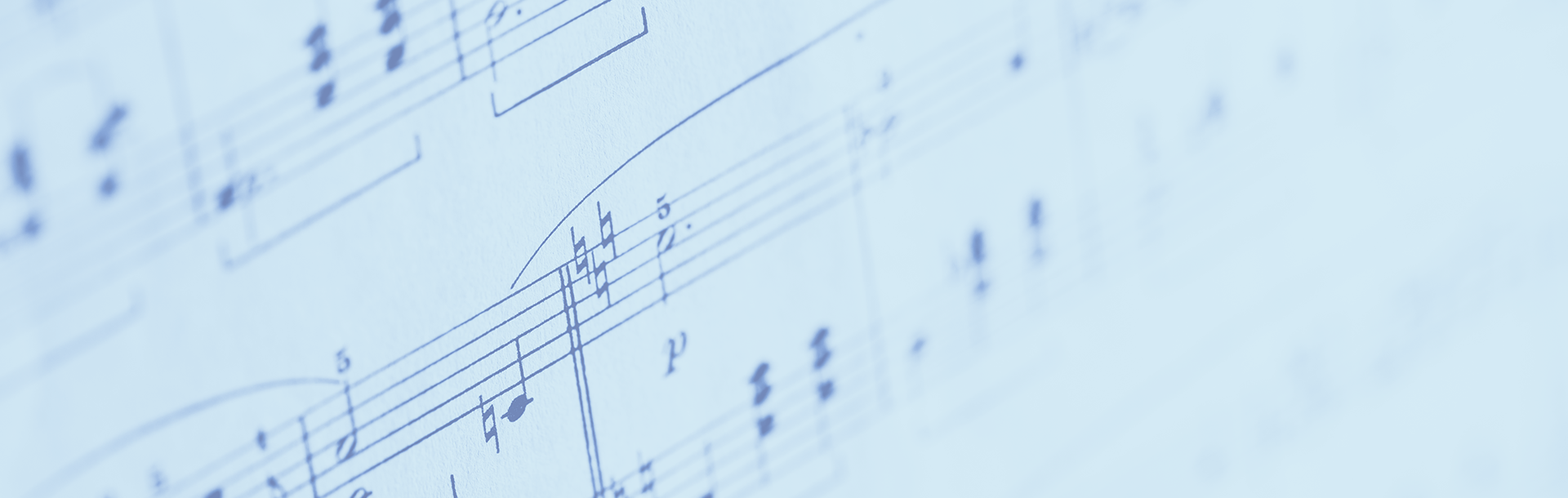  This image features a close-up view of a sheet of music, focusing on the staves and notes to create a soft, blurred effect.