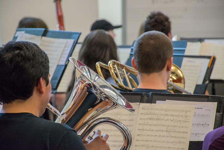 Concert band students playing instruments