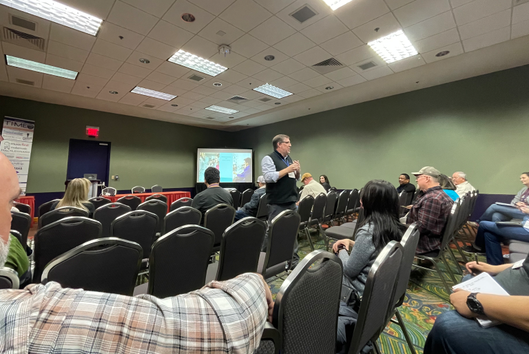 Dr. Jim Frankel giving a presentation in a conference room