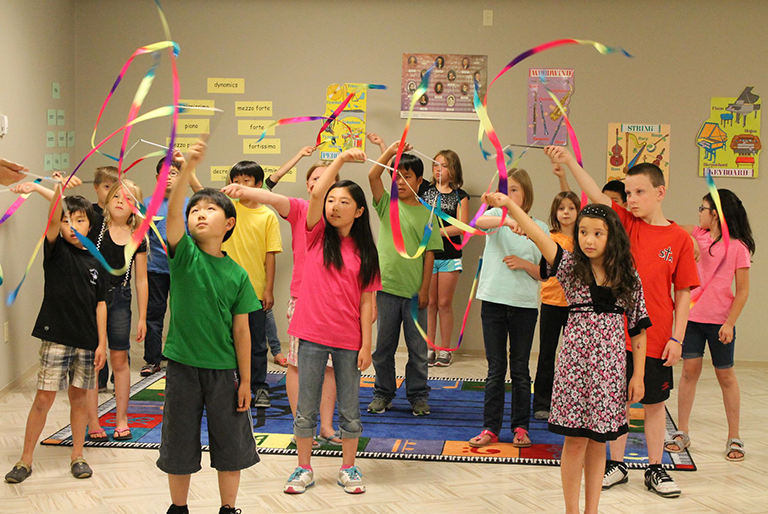 Kids playing with ribbon dancers